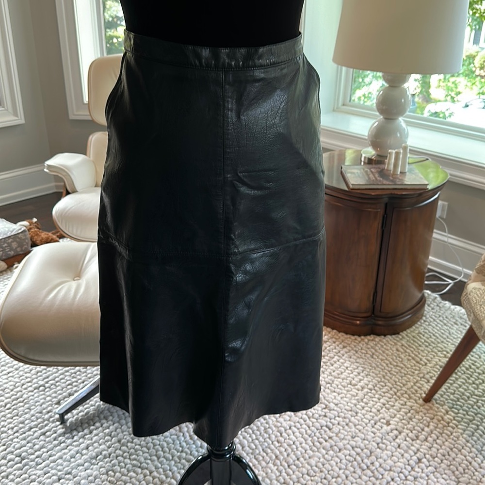 Faux Black Leather Skirt, A-line cut, back zipper, side pockets. Sisley size 12